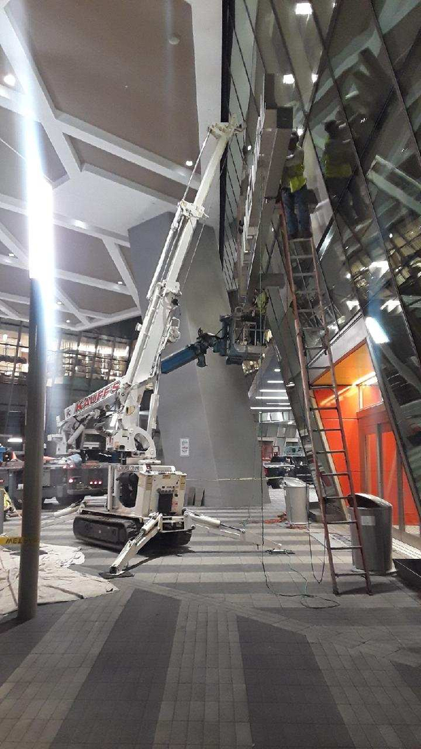 Cooper Crane mini spider crane working an indoor glass installation inside a Florida atrium
