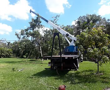Cooper Crane boom truck working over a Southeast Florida residential roofline